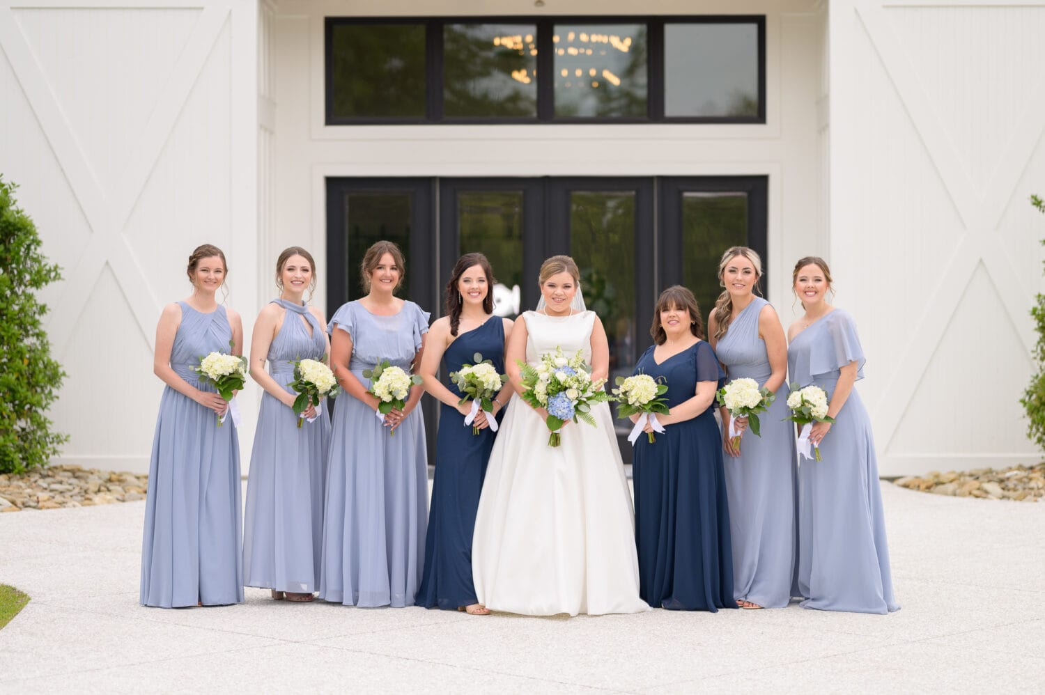 Bride with bridesmaids in front of the doors - The Venue at White Oaks Farm