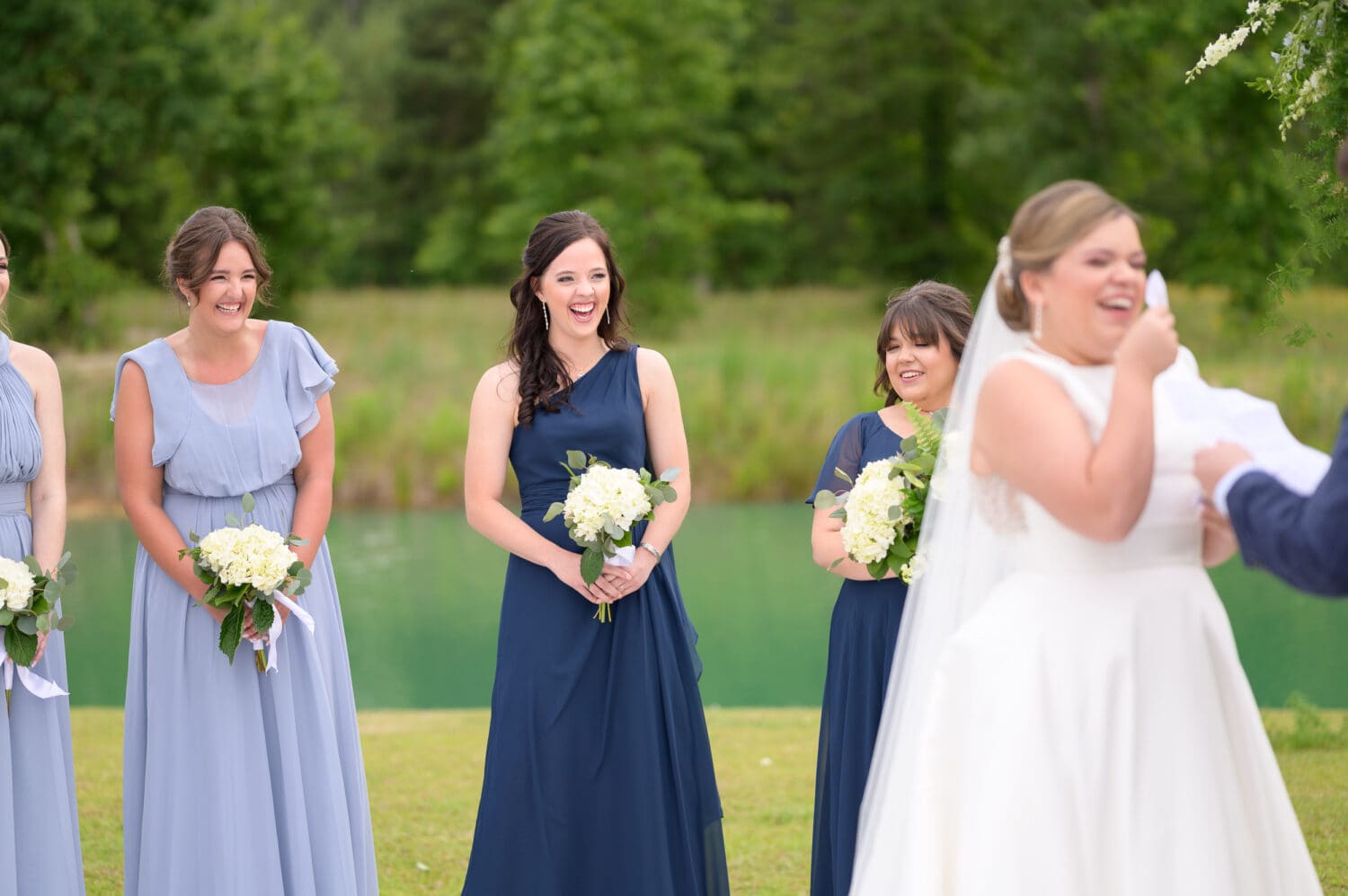 Bridesmaids laughing during the ceremony - The Venue at White Oaks Farm