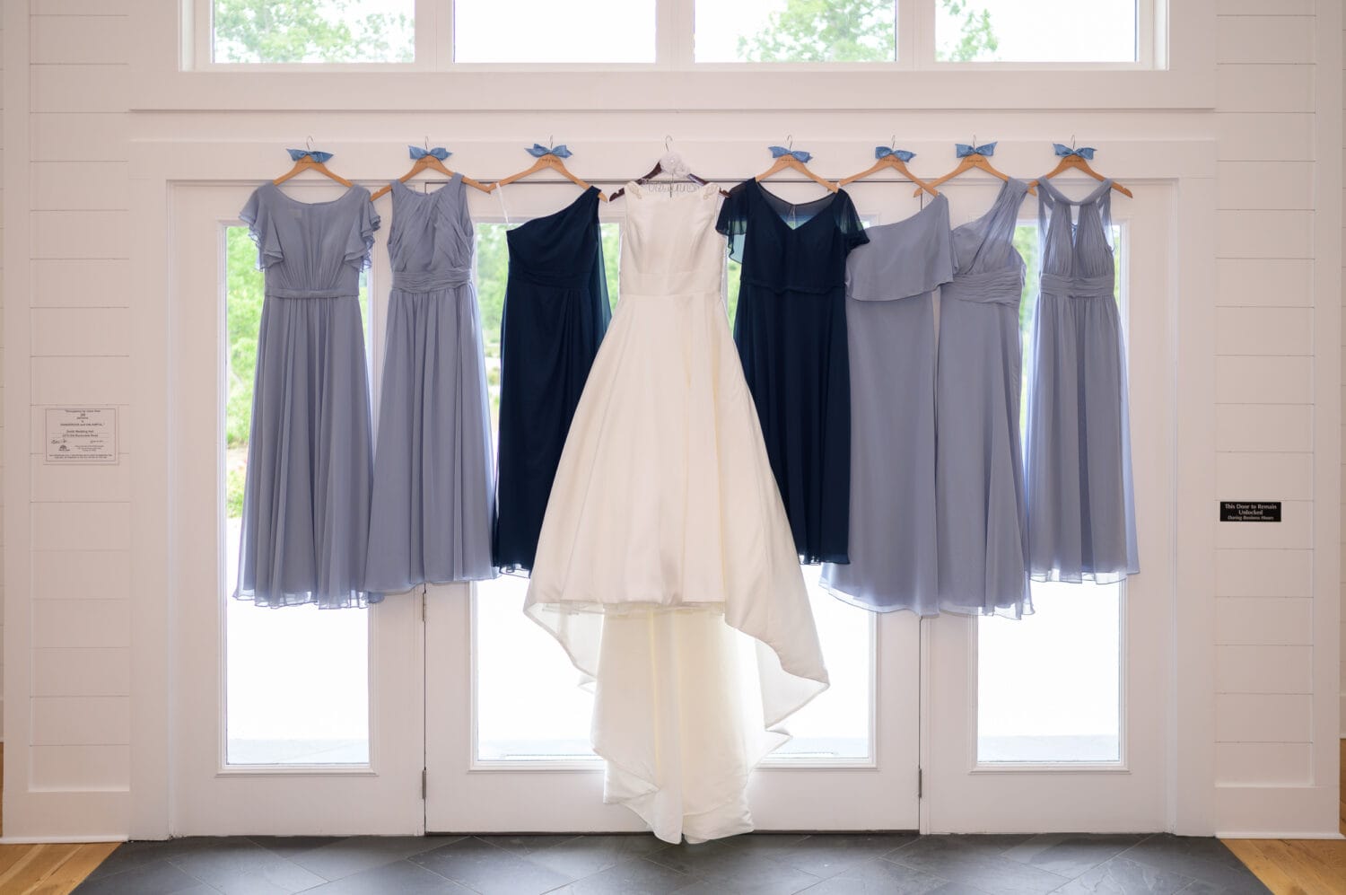 Dresses hanging in the windowlight  - The Venue at White Oaks Farm