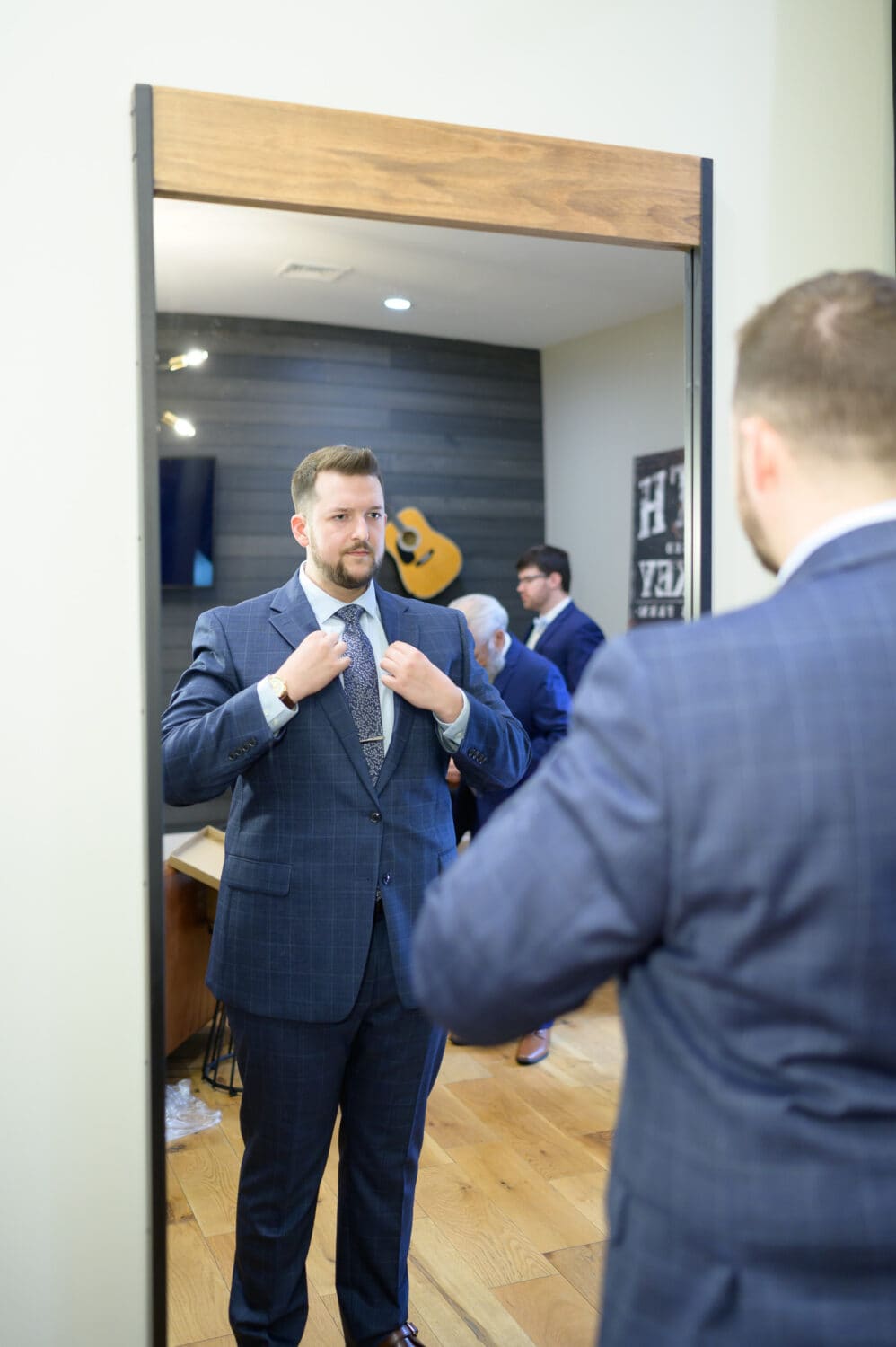 Groom checking out himself in the mirror - The Venue at White Oaks Farm