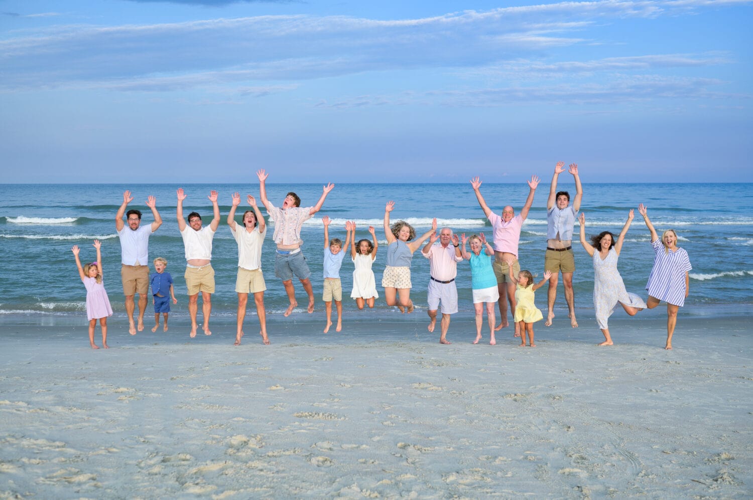 Happy family jumping in the air with grandparents - Pawleys Island