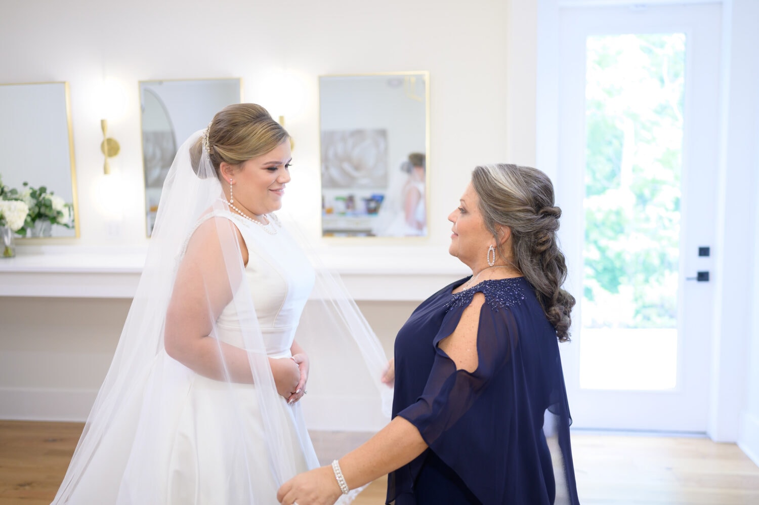 Mother helping bride with her veil - The Venue at White Oaks Farm