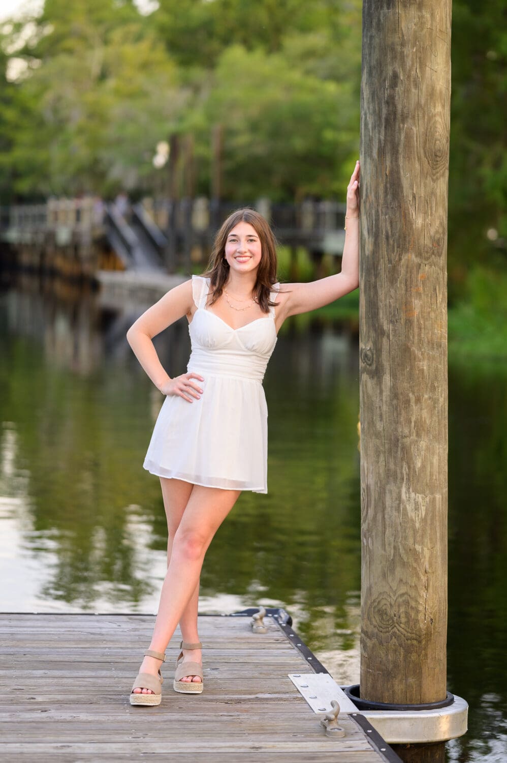 Senior portrait leaning on the dock on the river - Conway River Walk