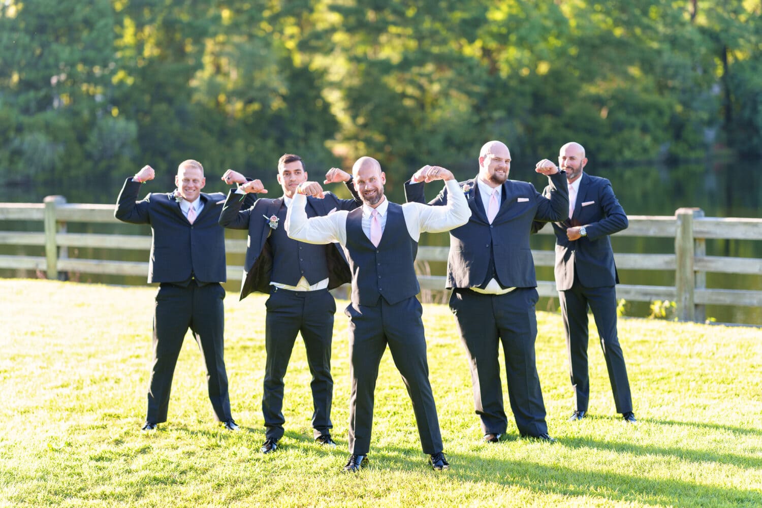 Bodybuilding groom showing off his muscles with the groomsmen - The Pavilion at Pepper Plantation