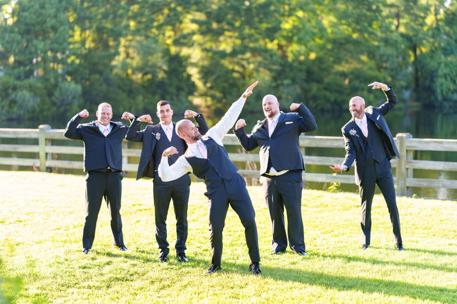 Bodybuilding groom showing off his muscles with the groomsmen - The Pavilion at Pepper Plantation