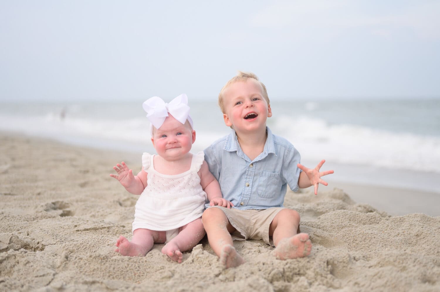 Cute infant cousins together on the beach - Huntington Beach State Park