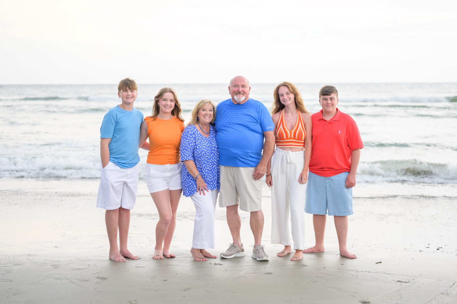 Family with colorful outfits having fun on the beach - Huntington Beach State Park