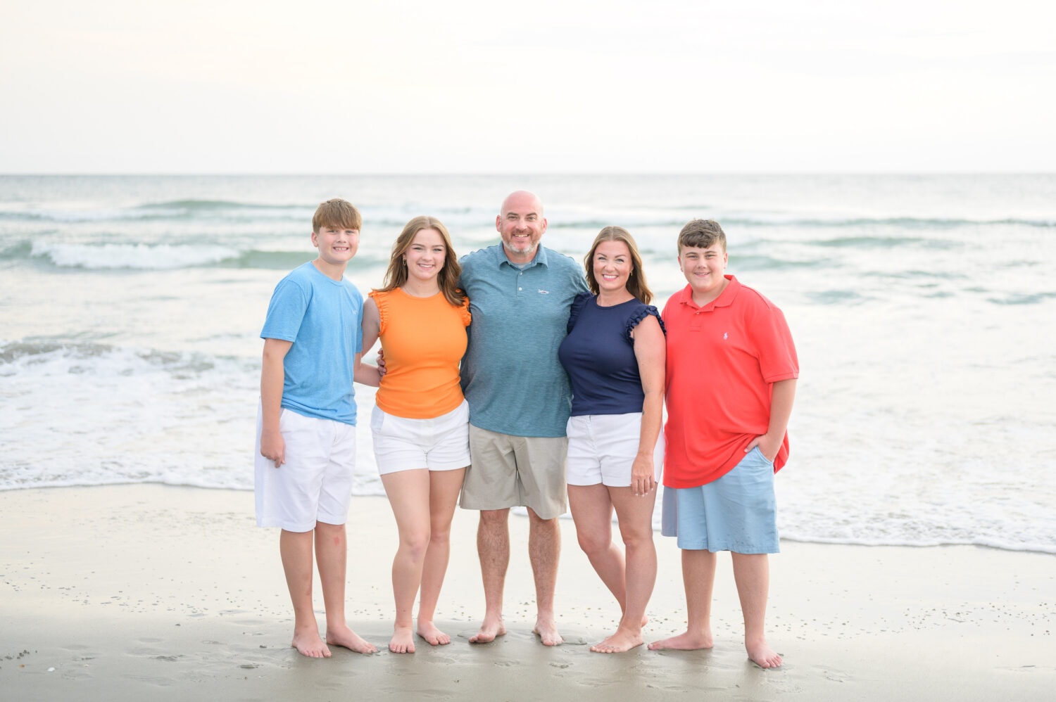 Family with colorful outfits having fun on the beach - Huntington Beach State Park