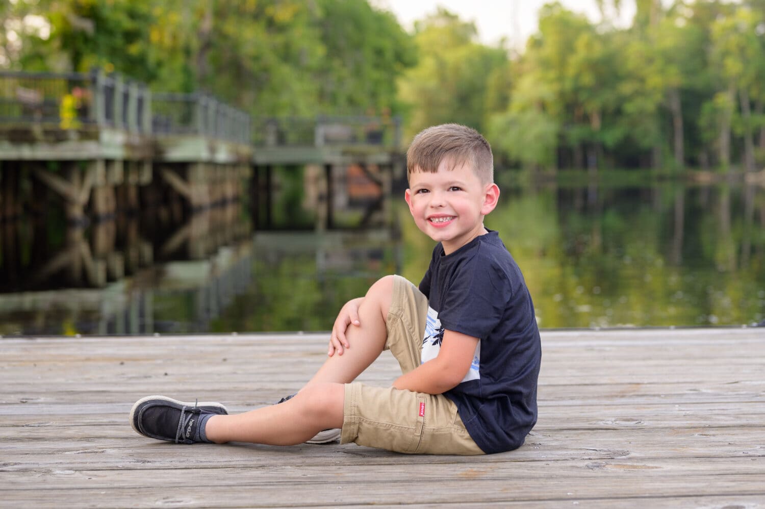 Little boy sitting on the dock - Conway Riverwalk