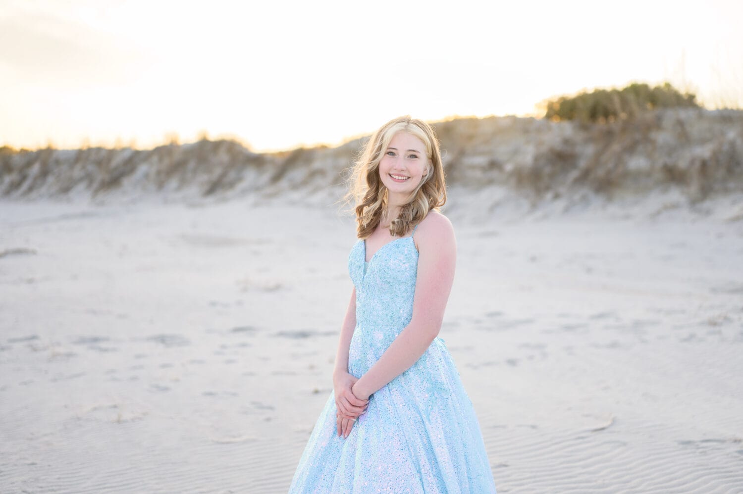 Prom portraits in a sparkly blue gown in front of the dunes - Huntington Beach State Park