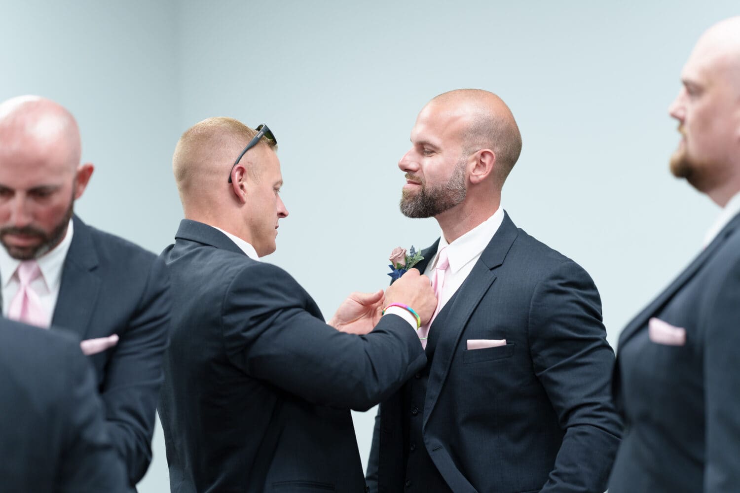 Putting on boutonniere before the ceremony - Hotel Indigo