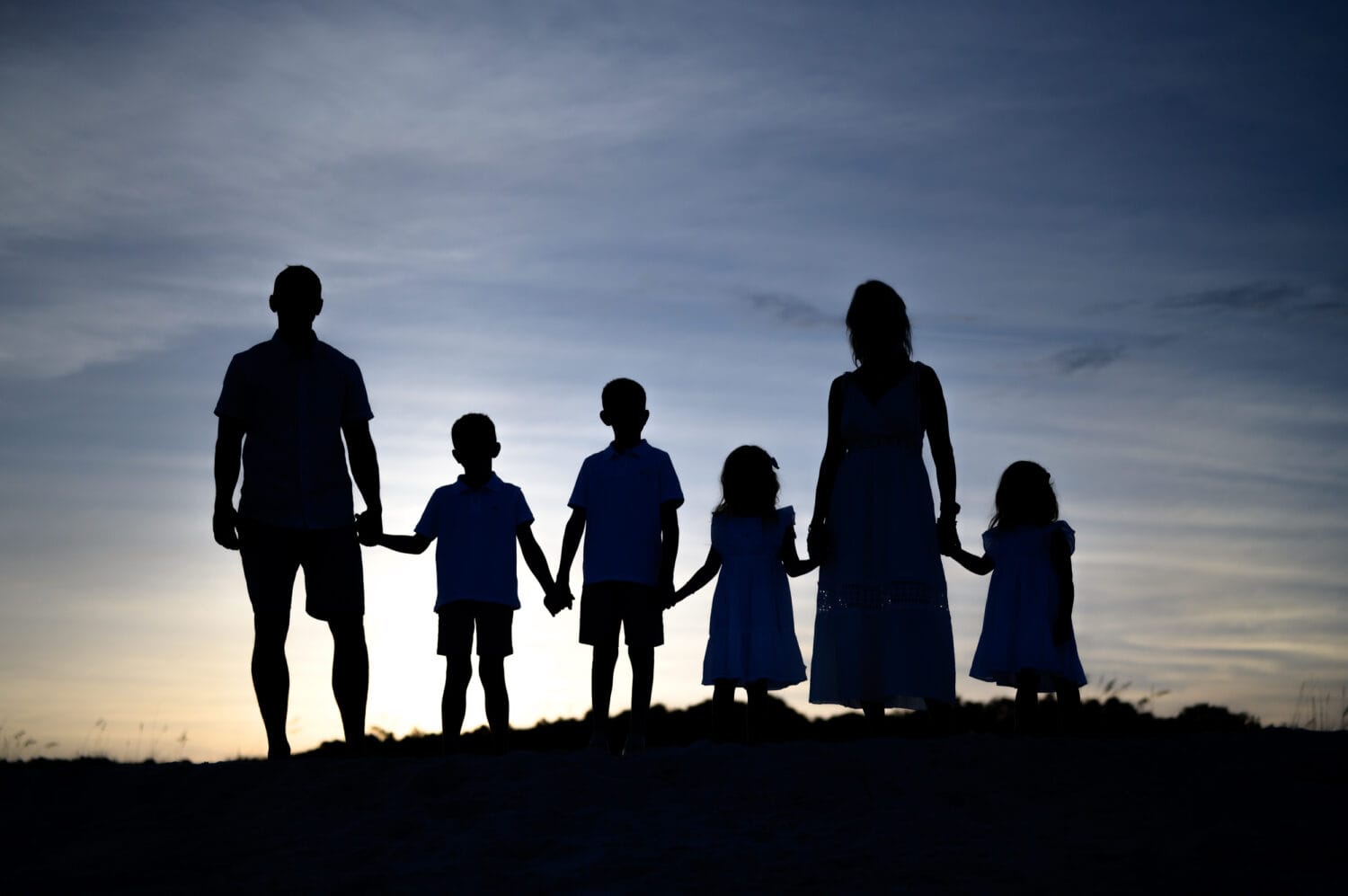 Silhouette of family by the ocean - Huntington Beach State Park