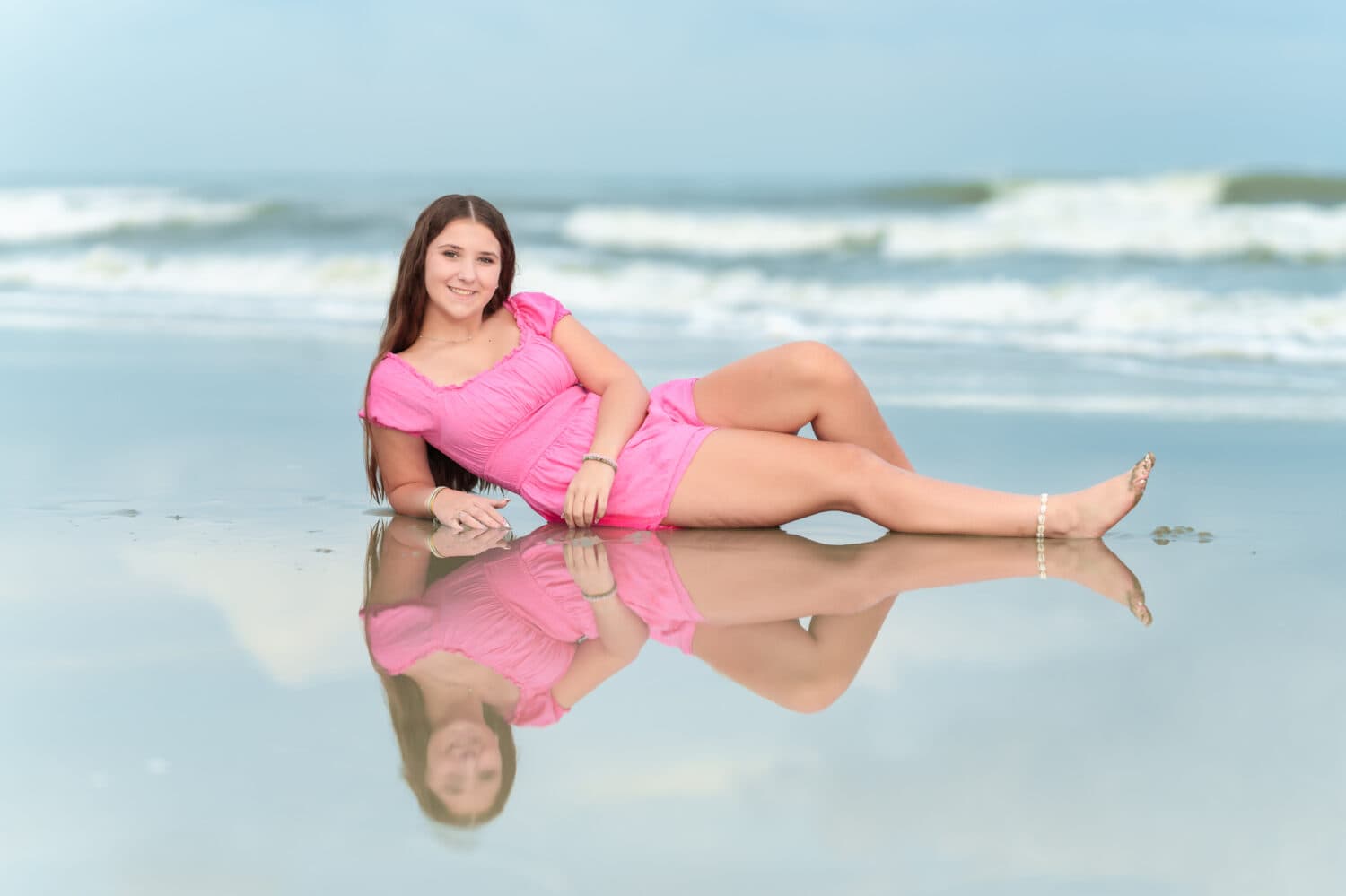 Senior portrait of girl laying in the ocean - Huntington Beach State Park