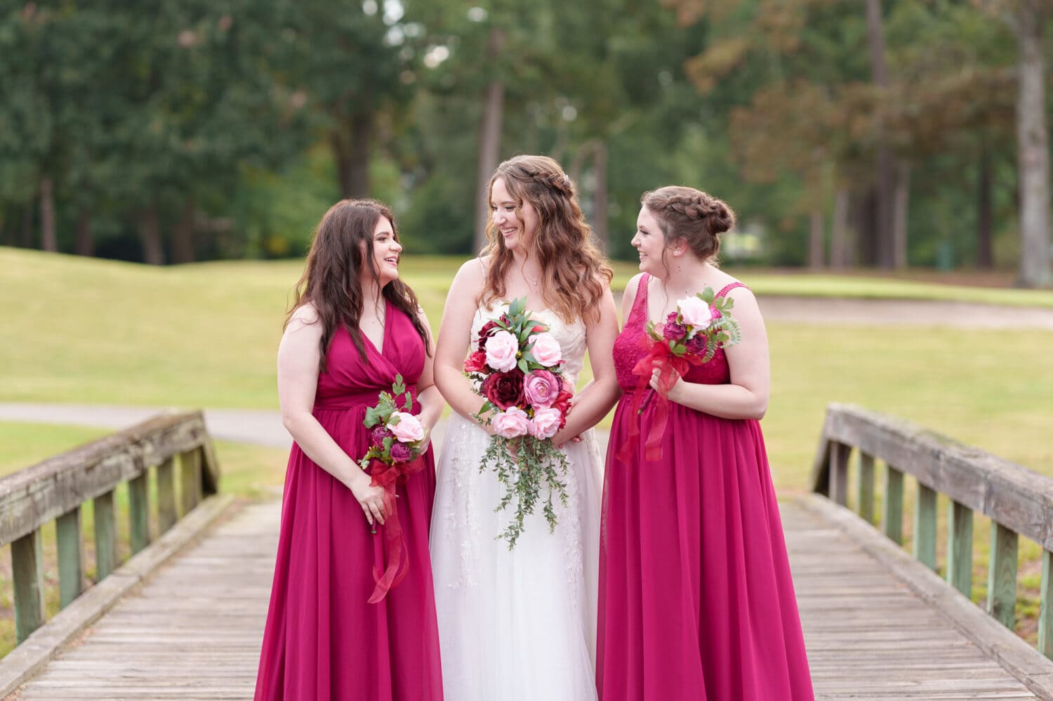 Bride and bridesmaids smiling at each other - Litchfield Country Club