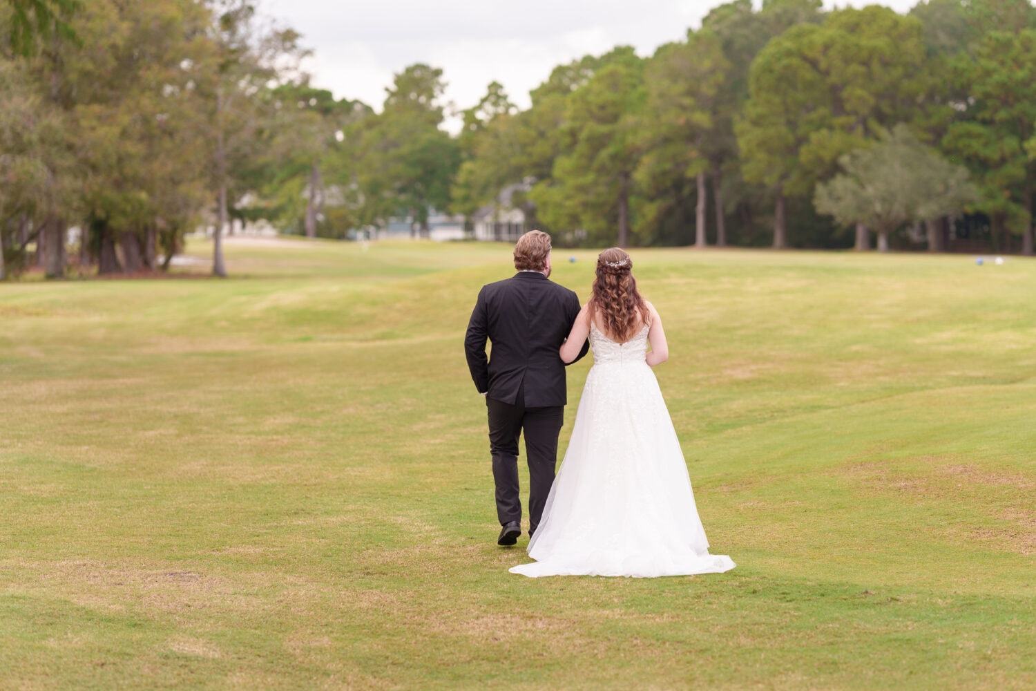 Bride and groom walking down the golf course - Litchfield Country Club