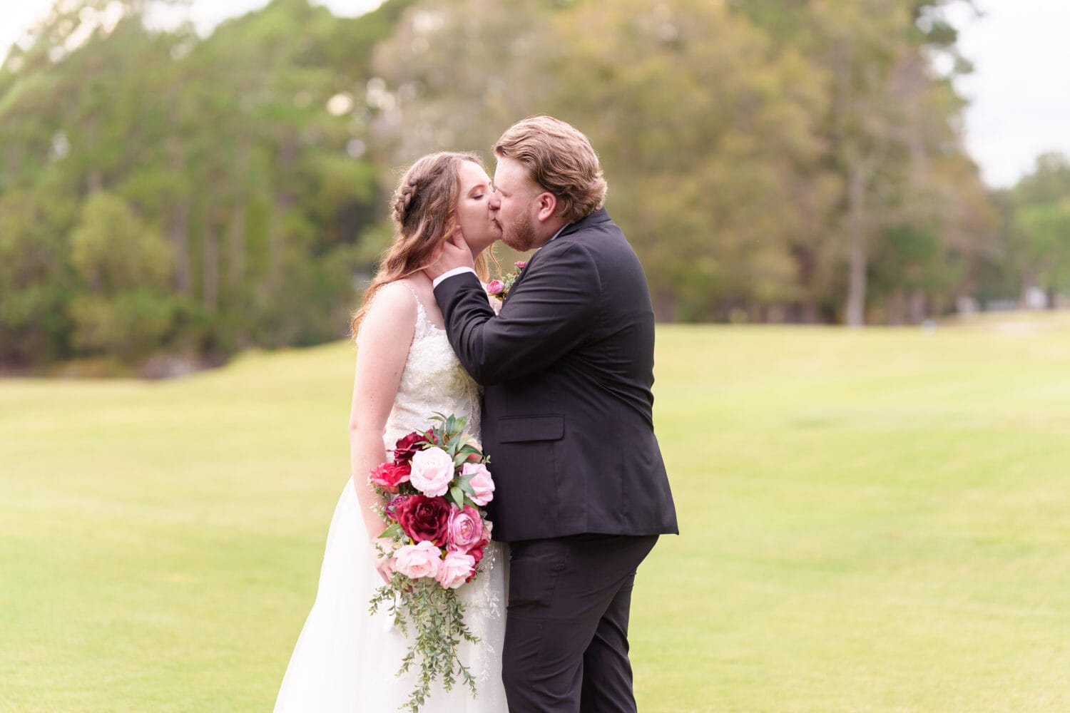 Groom pulling bride in for a kiss - Litchfield Country Club