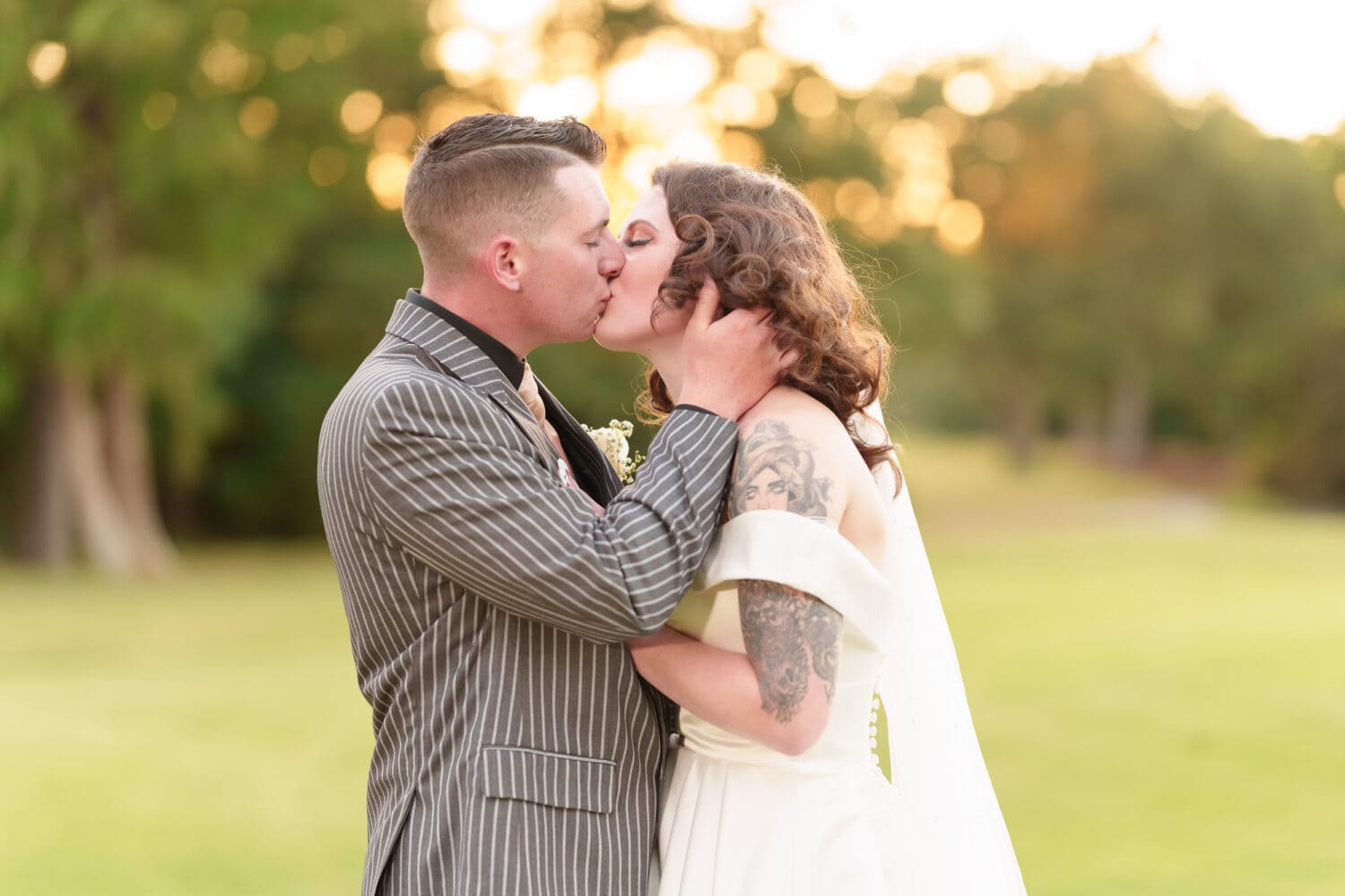 Kiss with bokeh balls from the sunset behind the bride and groom - Litchfield Country Club
