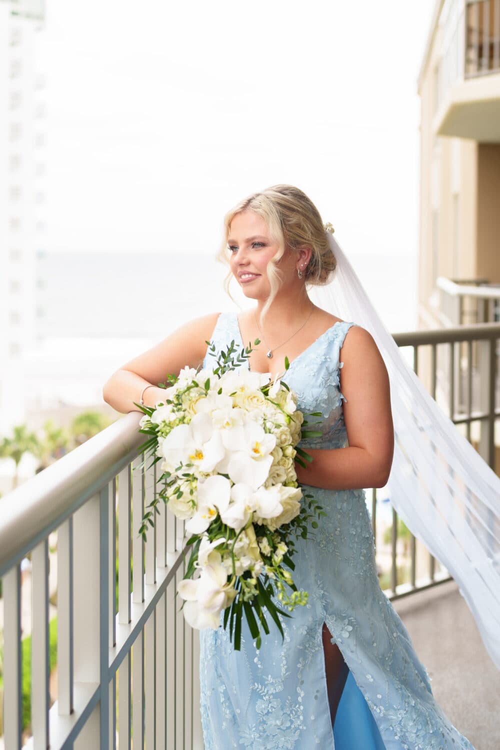 Bride looking out from the hotel balcony - Hilton Myrtle Beach Resort