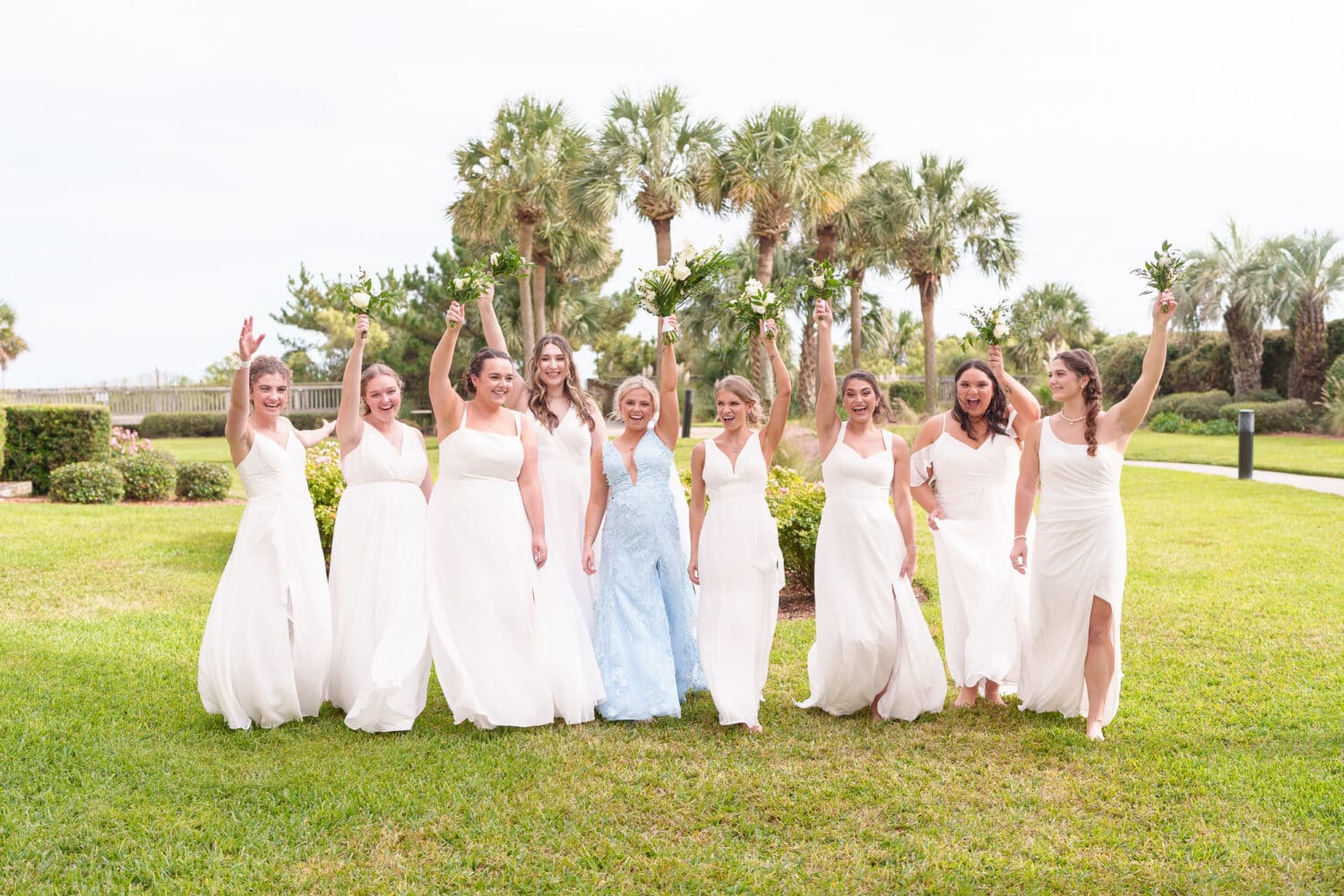 Bridesmaids holding flowers in the air - Hilton Myrtle Beach Resort