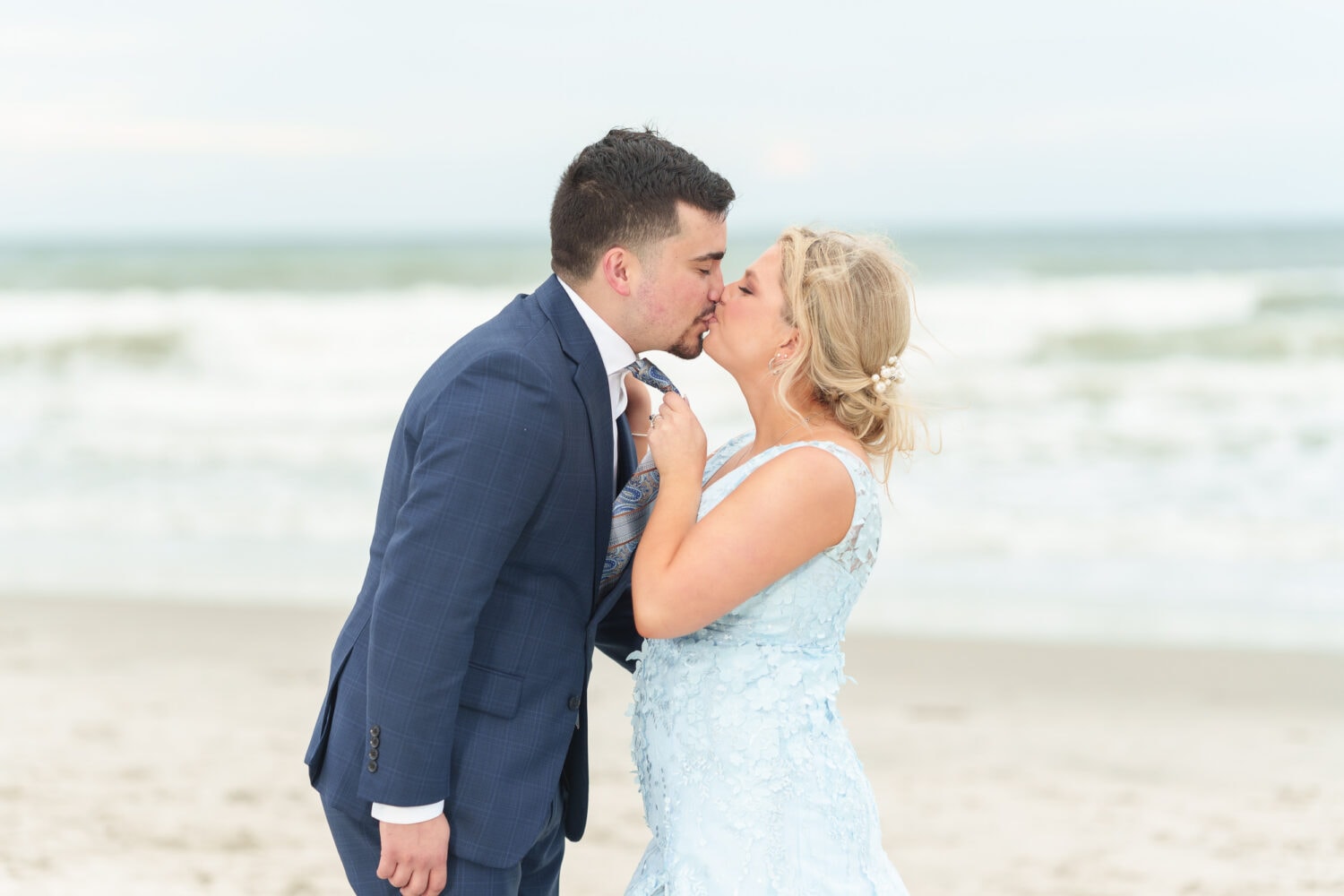 Pulling groom in for a kiss with his tie - Hilton Myrtle Beach Resort
