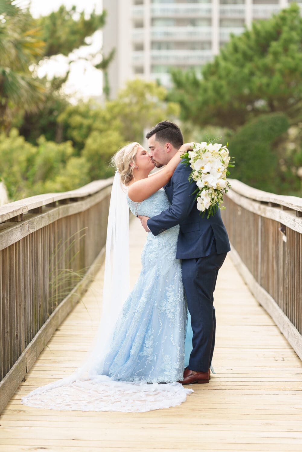 Romantic portraits with the bride and groom on a boardwalk after the first look - Hilton Myrtle Beach Resort