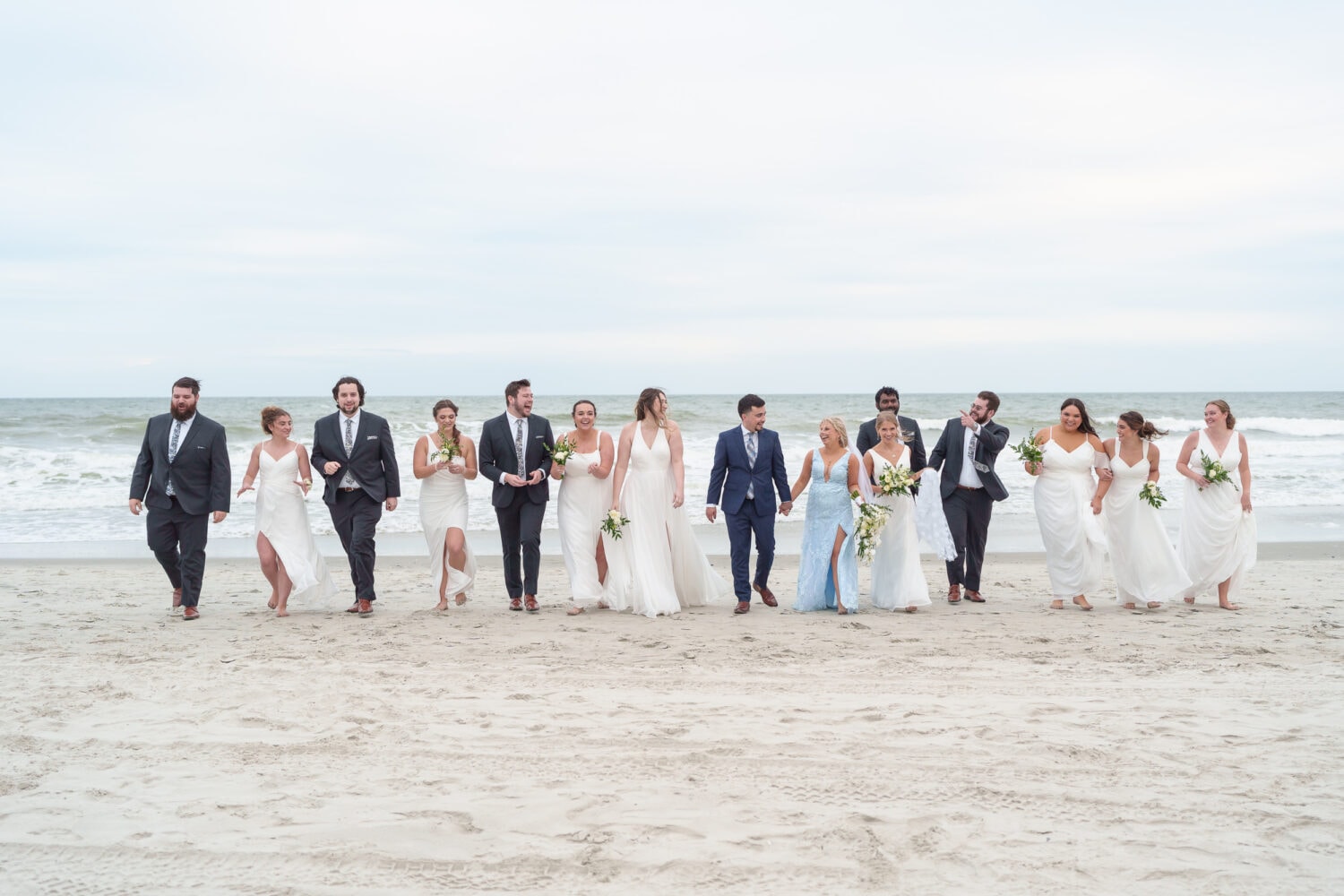 Wedding party walking down the beach together - Hilton Myrtle Beach Resort
