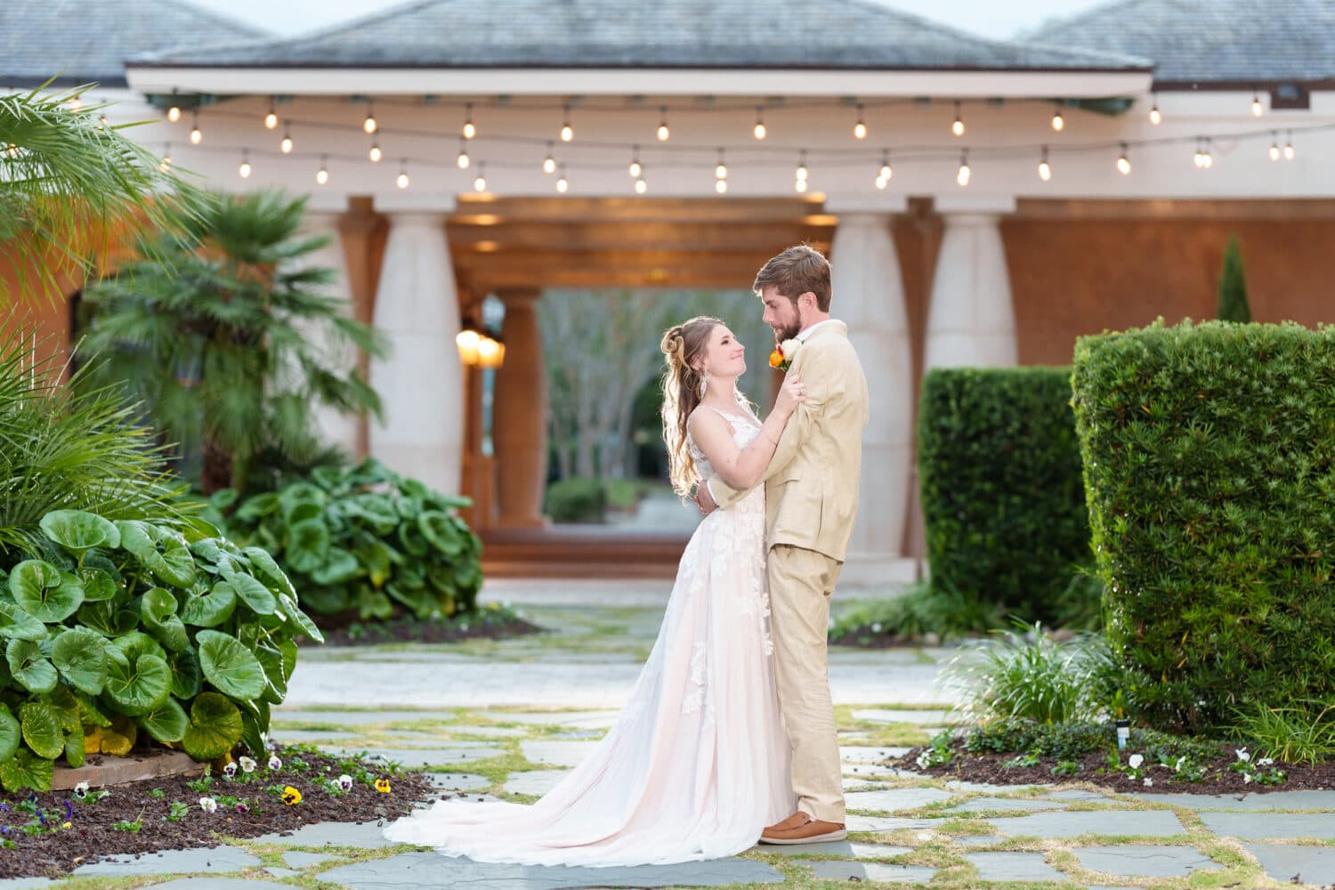 Bride and groom in the courtyard at dusk under the lights - 21 Main Events - North Myrtle Beach