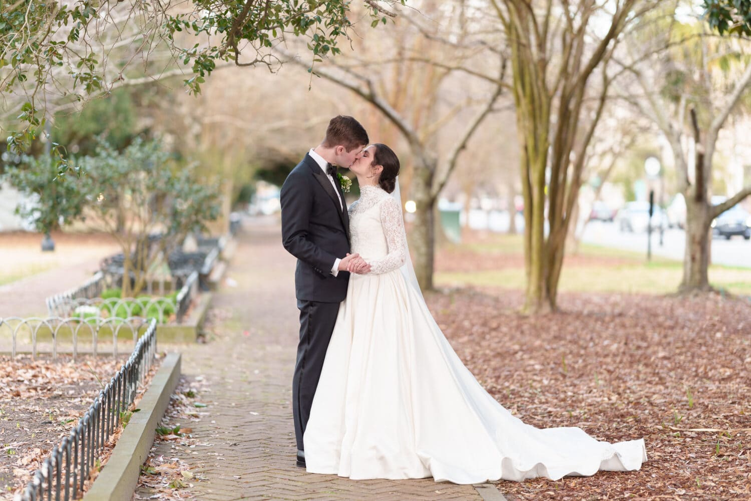 Bride and groom on the walkway in the park - Marion Square Charleston