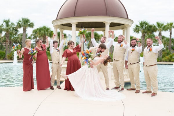 Dip back for a kiss with cheers from the wedding party - 21 Main Events - North Myrtle Beach