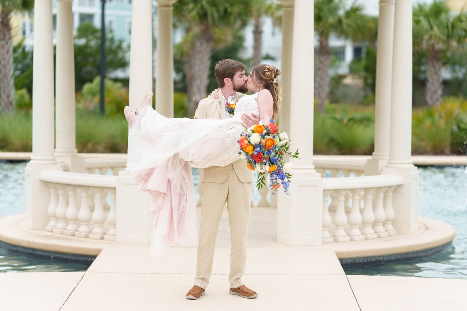Groom lifting bride up for a kiss - 21 Main Events - North Myrtle Beach