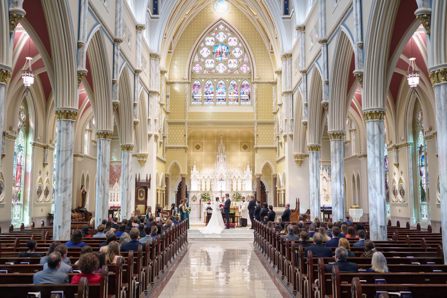 Holding hands during the ceremony - Cathedral of Saint John Charleston