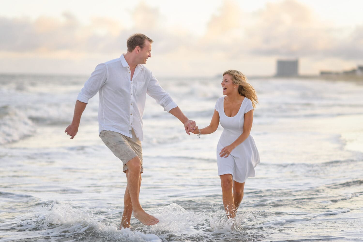 Couple having fun walking through the ocean together - Myrtle Beach State Park
