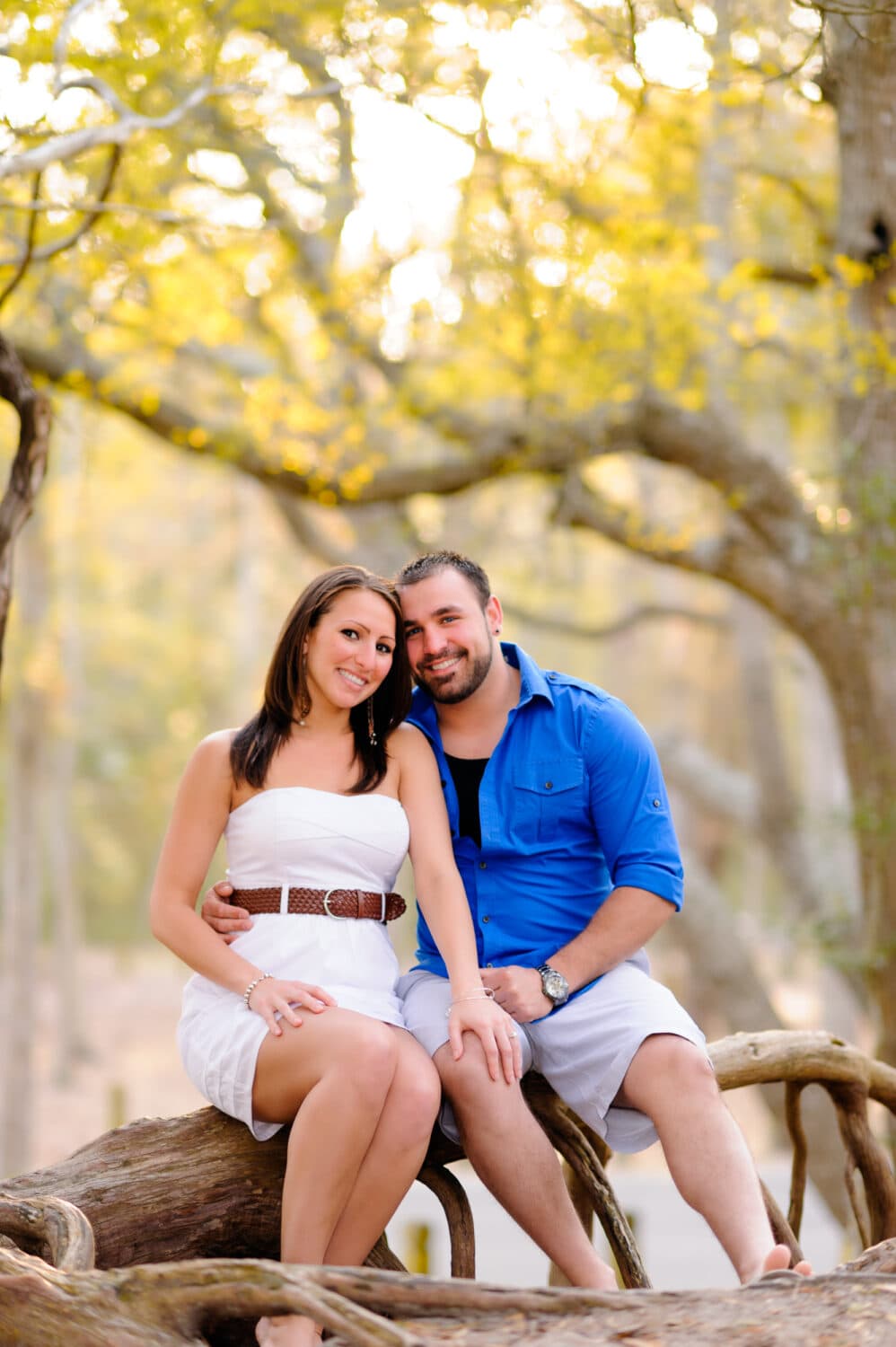Couple sitting in front of the light coming through the trees - Myrtle Beach State Park