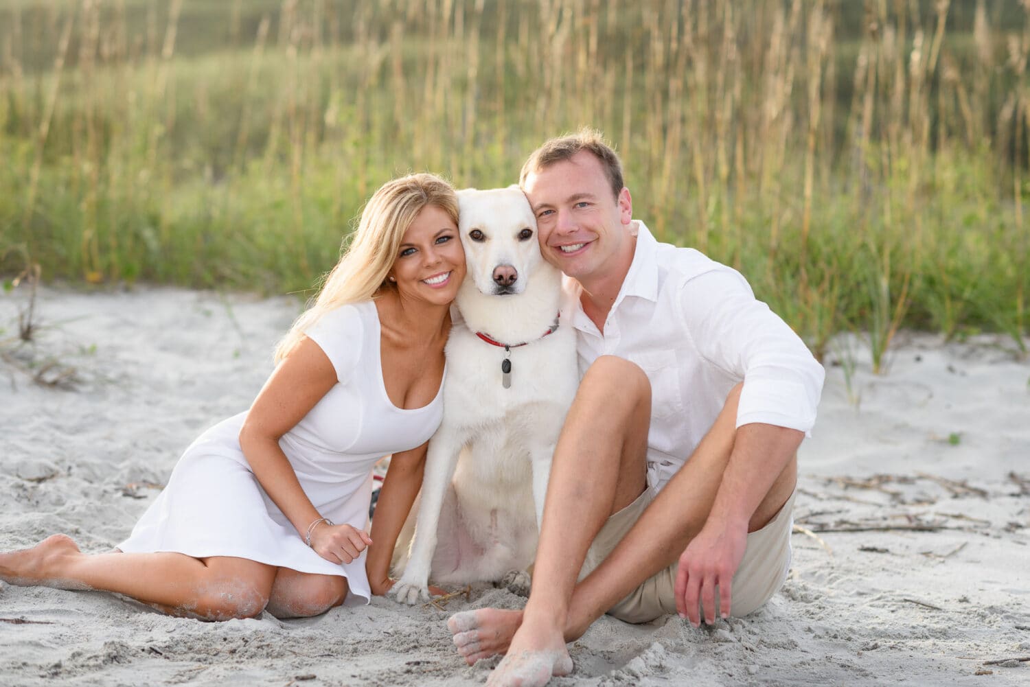 Couple snuggling with dog by the dunes - Myrtle Beach State Park