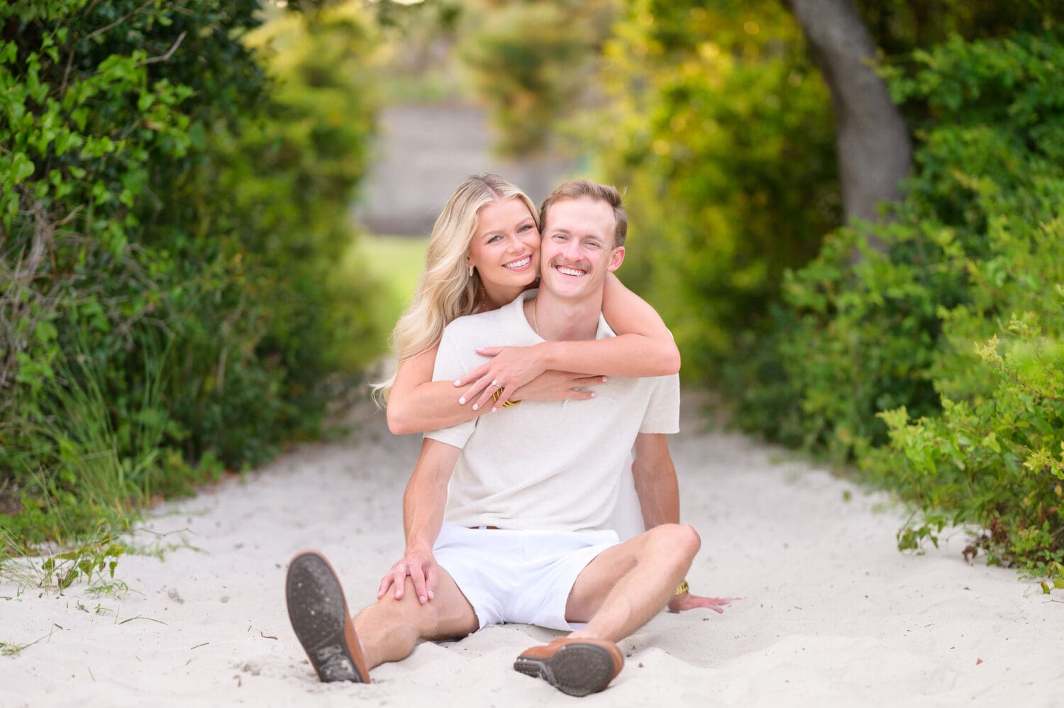 Cute couple for engagement pictures with a beautiful sunset - Huntington Beach State Park