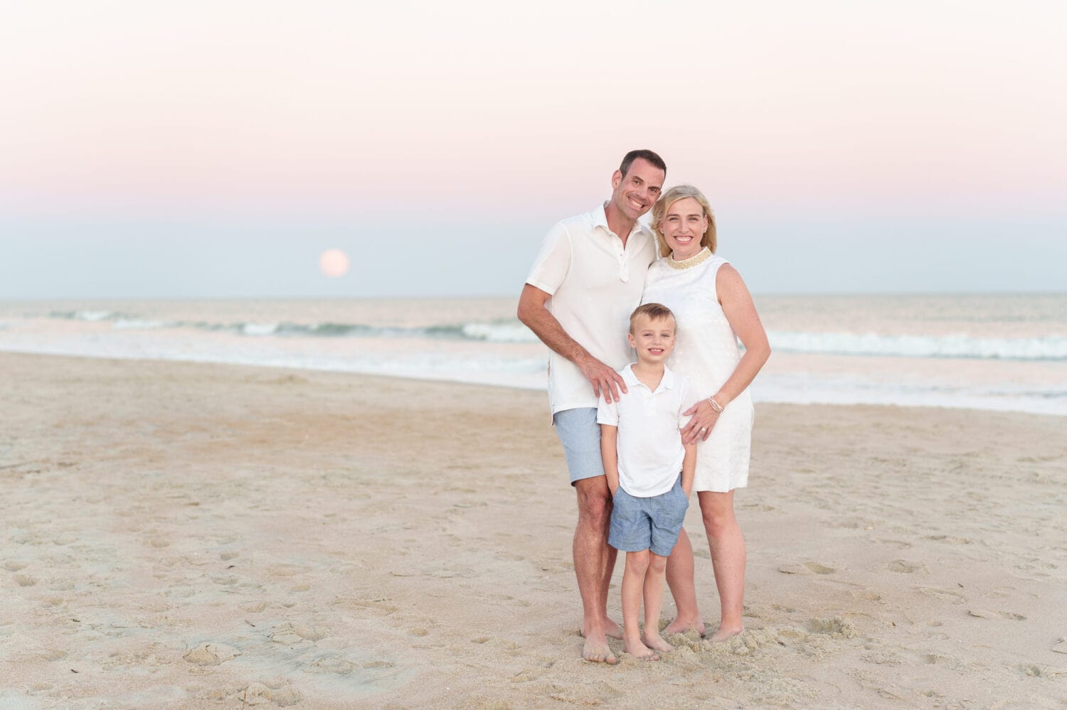 Family with moon rising over the ocean - Huntington Beach State Park
