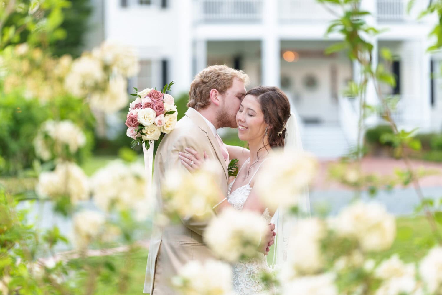 Bride and groom behind the flowers - Tanglewood Plantation