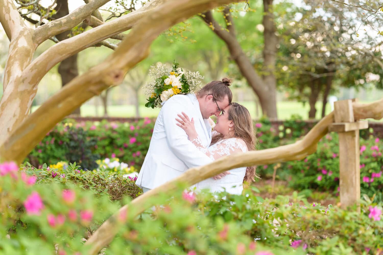 Bride and groom under the trees in the garden - Pine Lakes Country Club