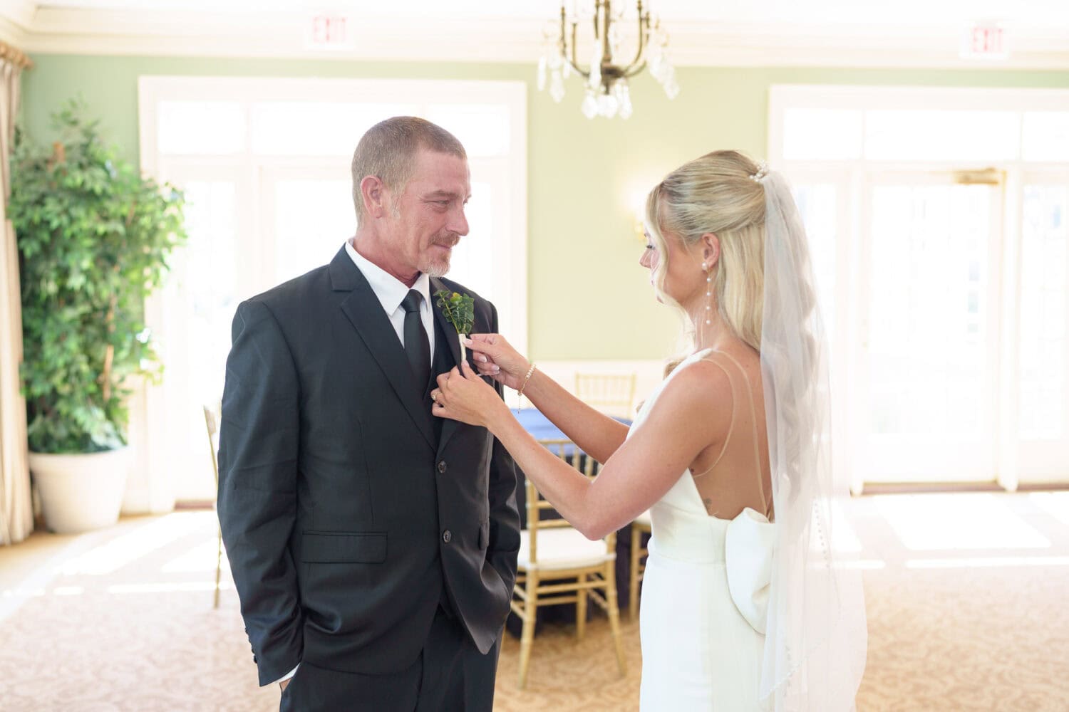 Bride helping father with boutonniere  - Pawleys Plantation