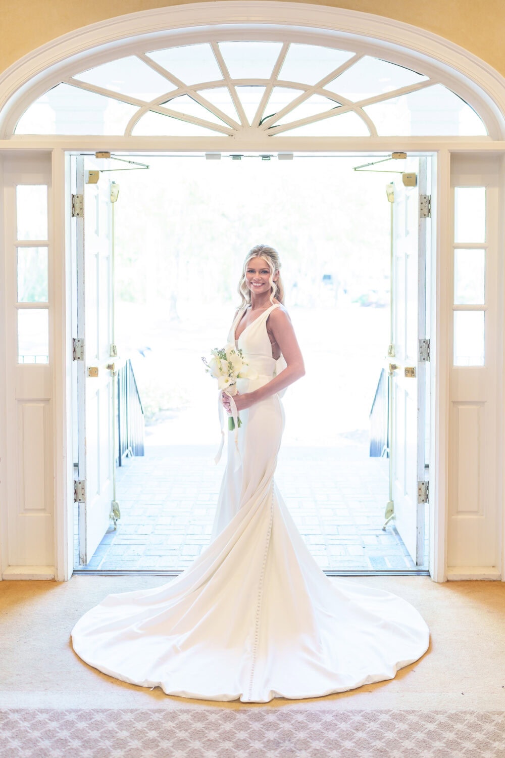 Bride with dress behind her standing in the doorway - Pawleys Plantation