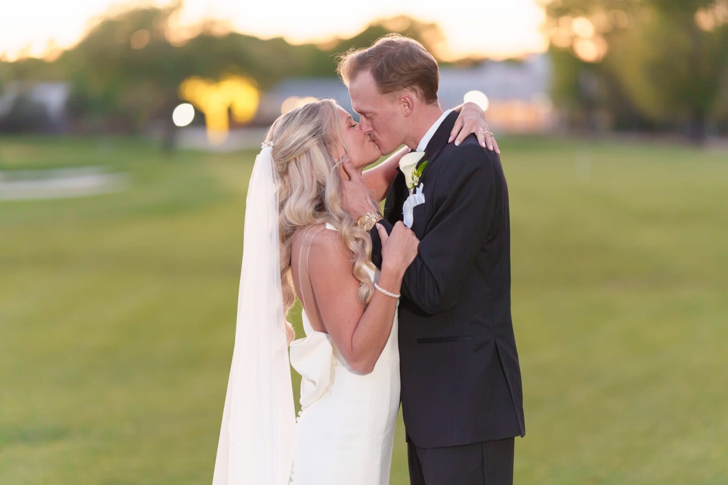 Kiss with the lights of the clubhouse in the background - Pawleys Plantation