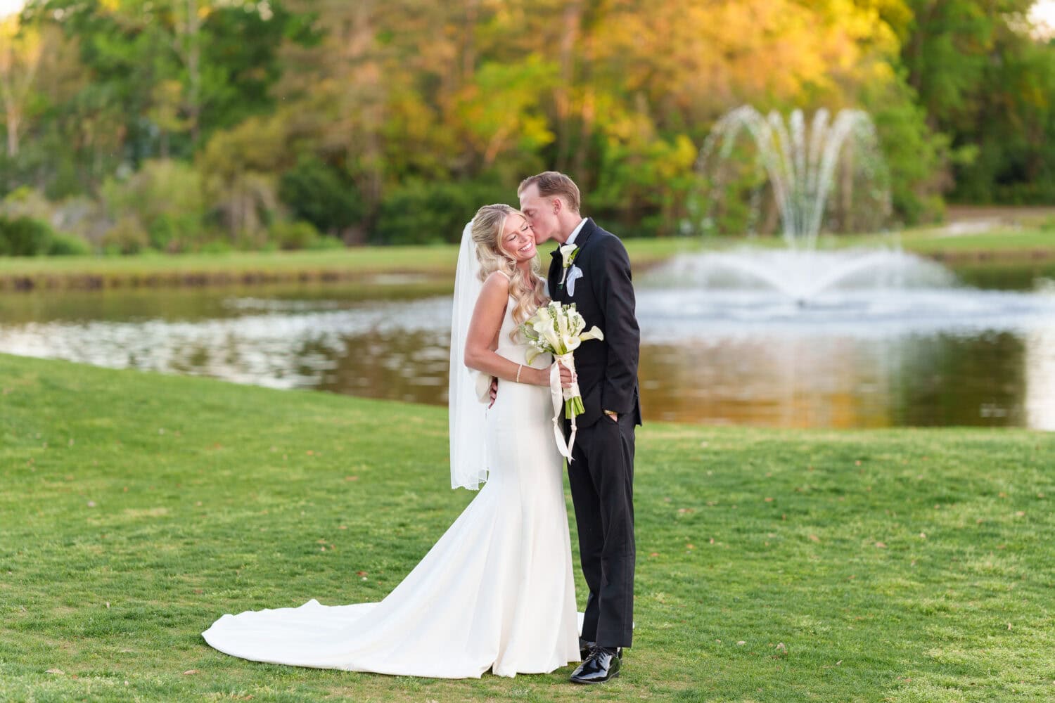 Portraits of the bride and groom in front of the lake and fountain - Pawleys Plantation