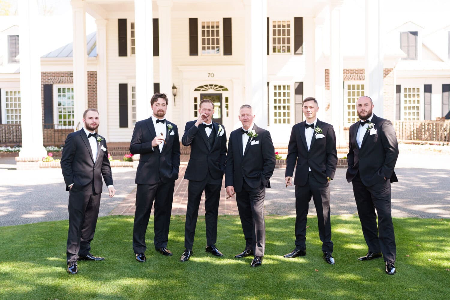Portraits of the groom and groomsmen in front of the clubhouse - Pawleys Plantation