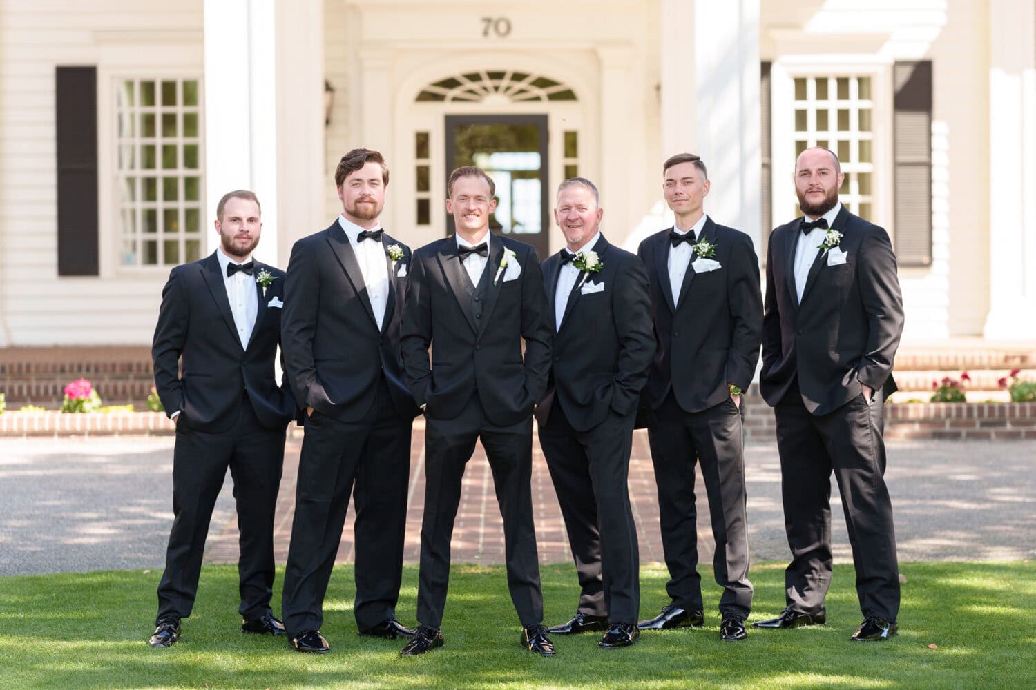 Portraits of the groom and groomsmen in front of the clubhouse - Pawleys Plantation