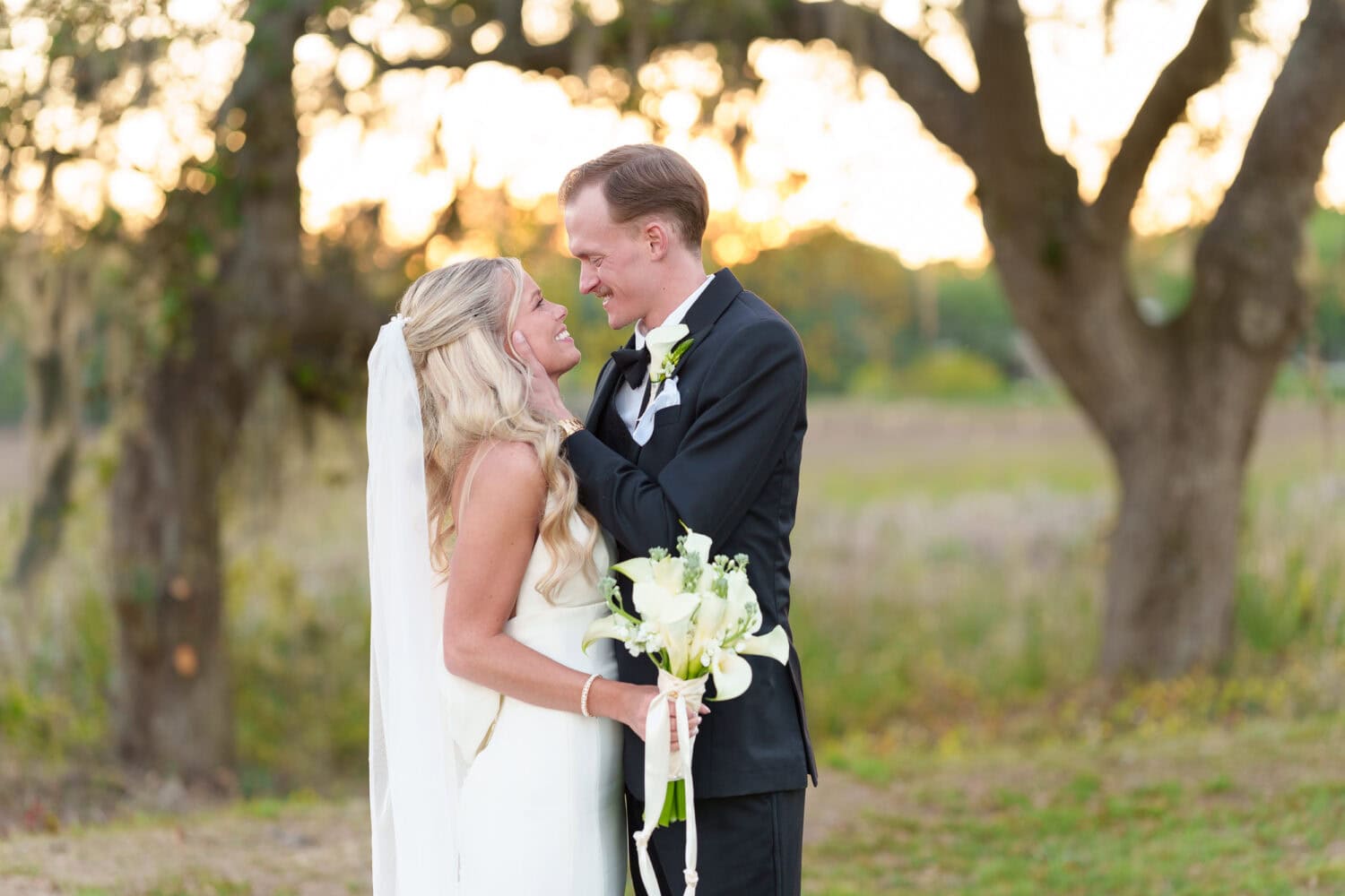 Pulling bride in for a kiss - Pawleys Plantation