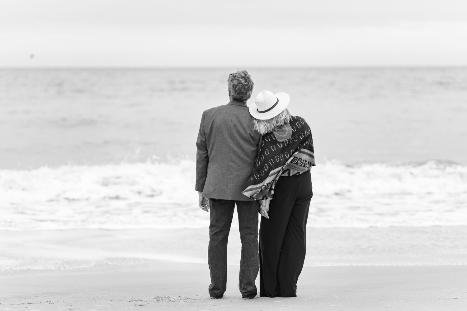 Senior couple looking out at the ocean in black and white - Huntington Beach State Park