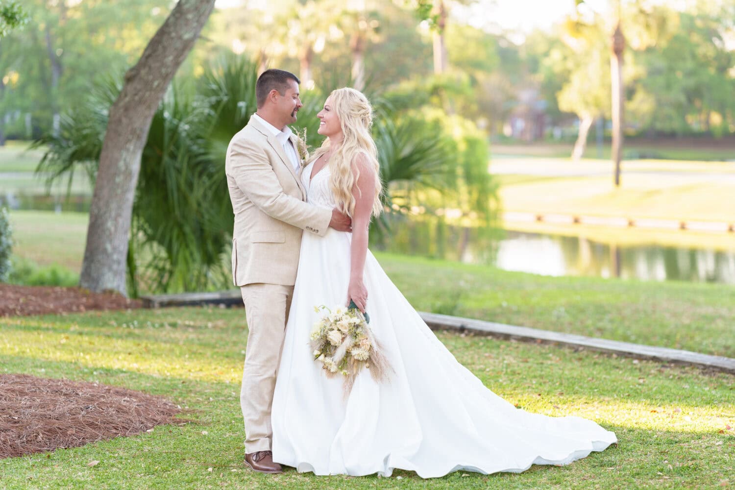 Bride and groom in front of the palms - The Village House at Litchfield