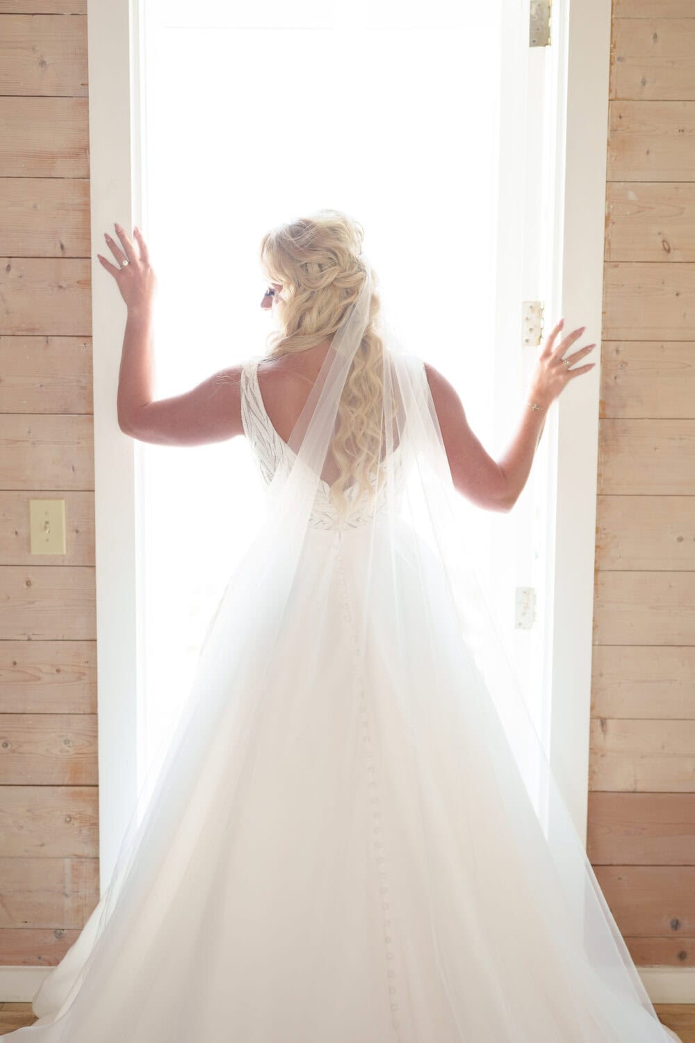 Bride standing in the doorway light - Beach House in Pawleys Island